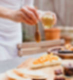 Thumbnail: Person drizzling honey onto brie cheese