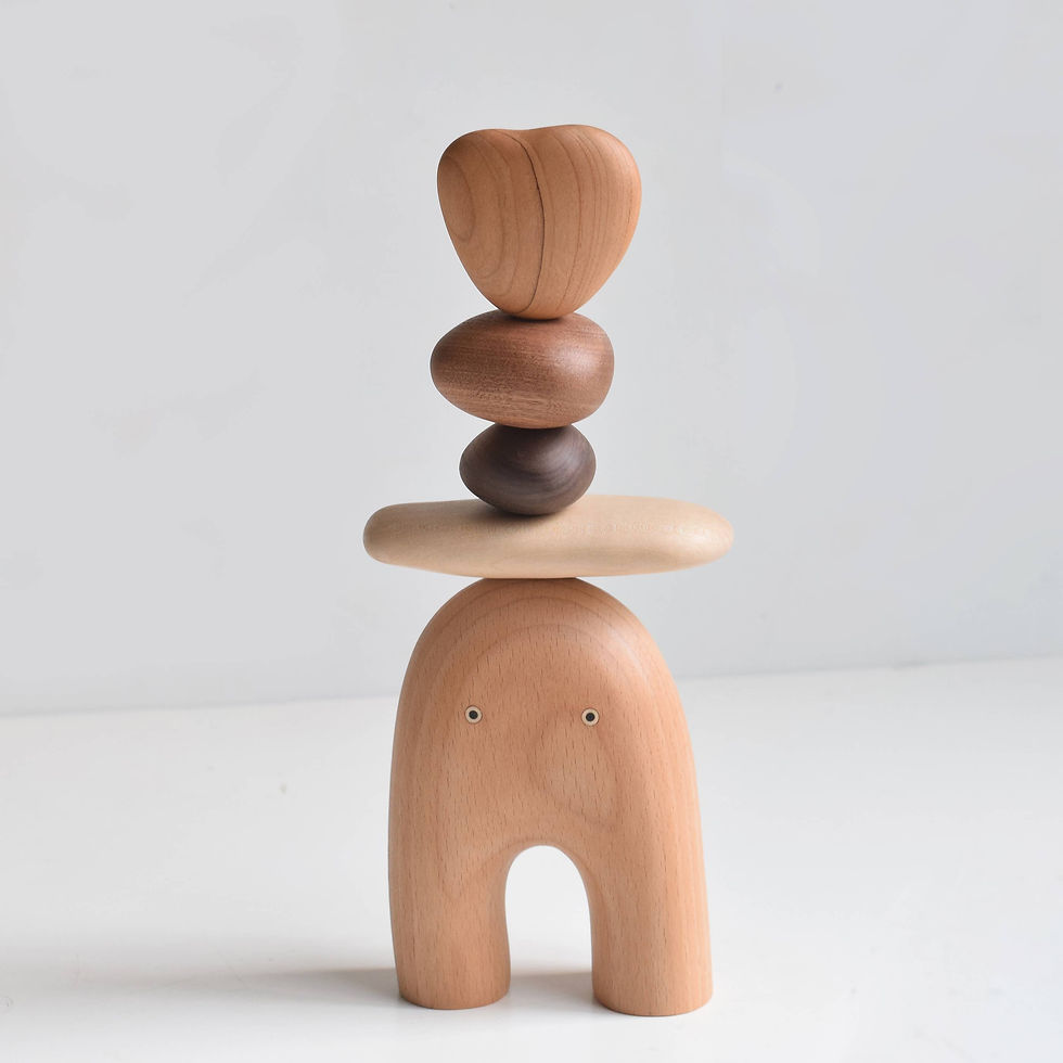 Balanced wooden sculpture with heart-shaped top