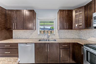Modern kitchen in miami with clean surfaces, updated appliances, and stylish decor, captured for a Miami real estate listing.