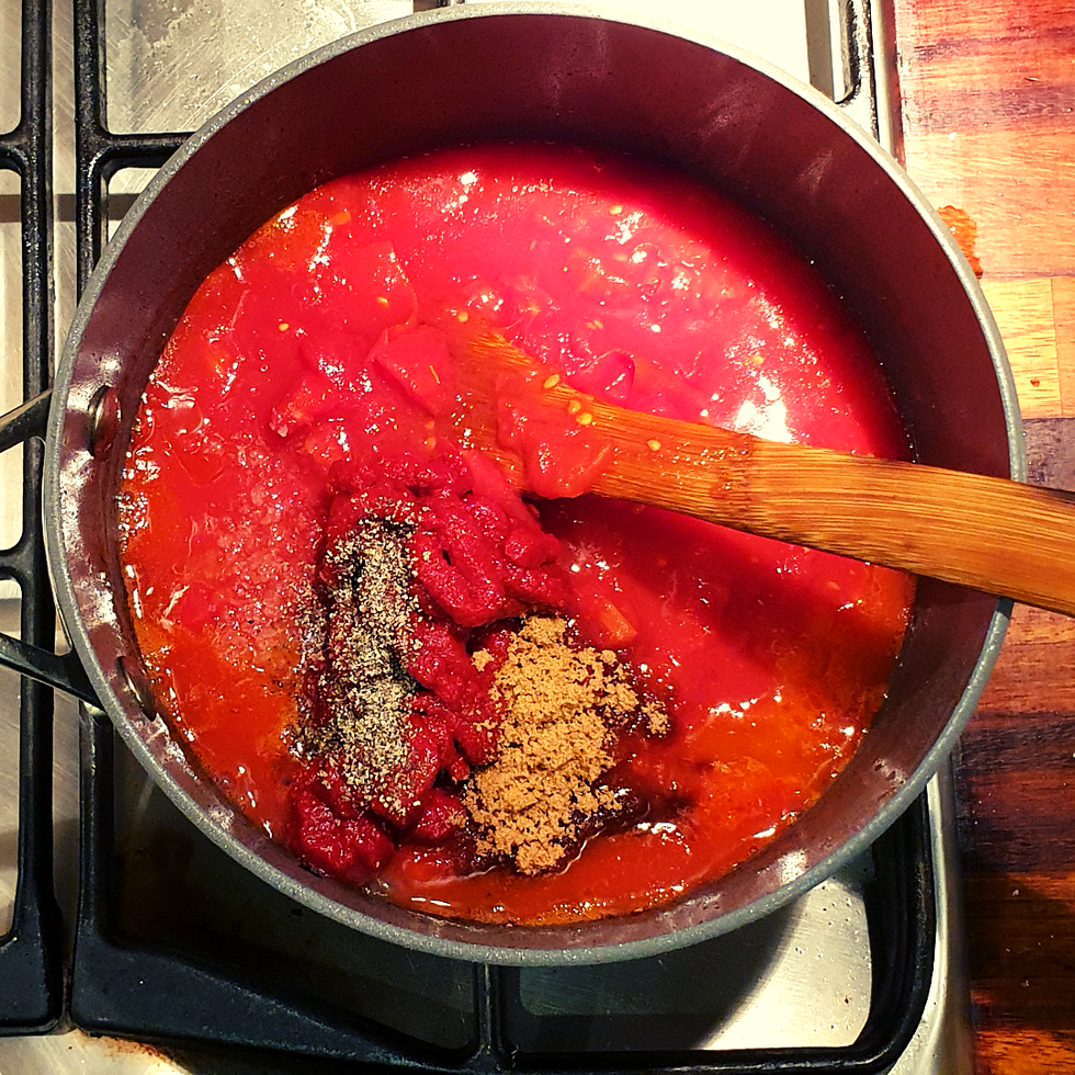 Add tomatoes, puree, sugar and seasoning to taste.