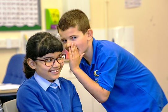 Children smiling and whispering