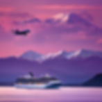Island with purple sunset with a snow capped mountain in the background and a cruise ship