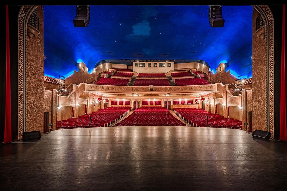 The stunning interior of the Paramount Theatre in Abilene, Texas, viewed from the stage, showcasing its classic design and seating area under a starry ceiling.