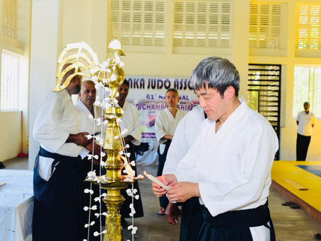Shihan Tomohiro Mori lights a ceremonial Sri Lankan oil lamp