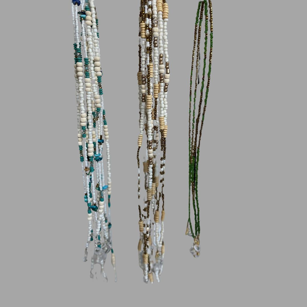 beaded custom sunglass straps hanging up in blue colours , sand colours and bokke colours