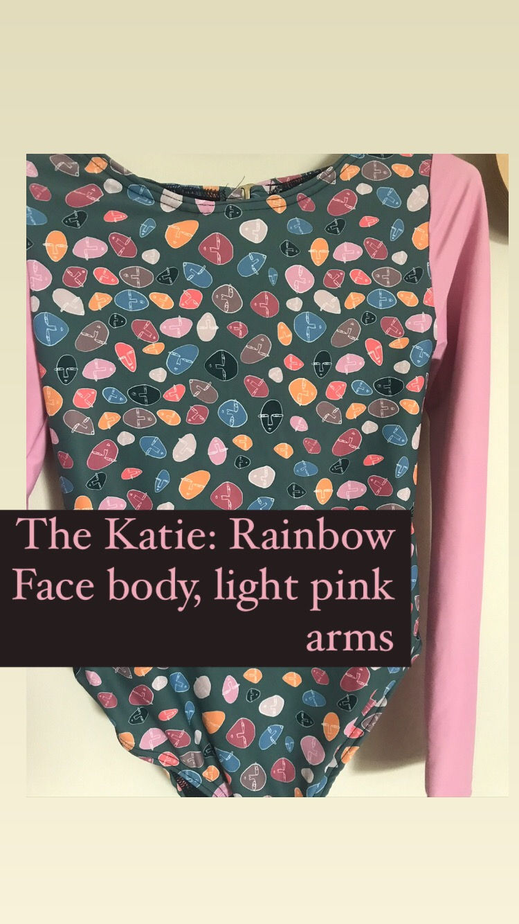 Thumbnail: surf capsule with rainbow faces print on the body and pink sleeves.
