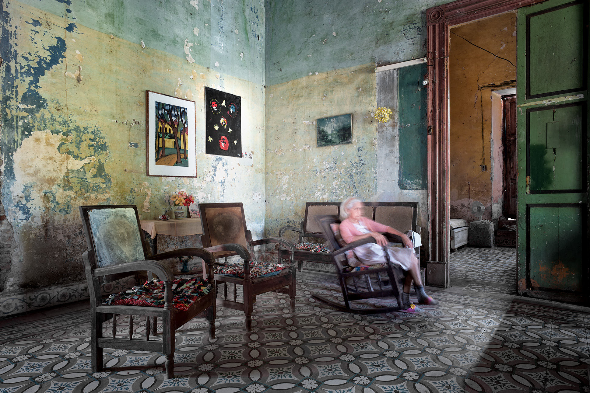 Photographic print of woman sitting in rocking chair in room
