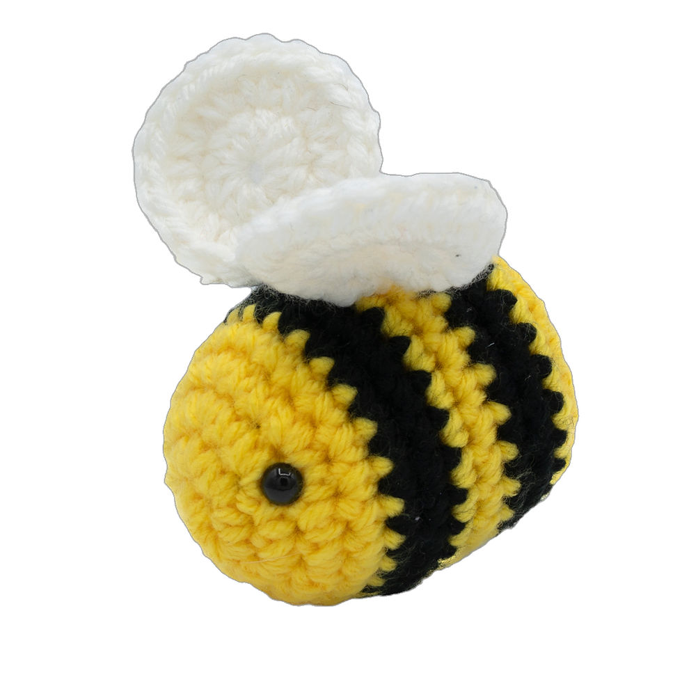 Amigurumi Bee Plushie, yellow and black striped body, white wings, cute design, close-up view.