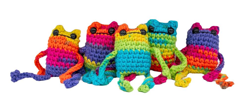 Five colourful crochet frogs with rainbow patterns on a white background.