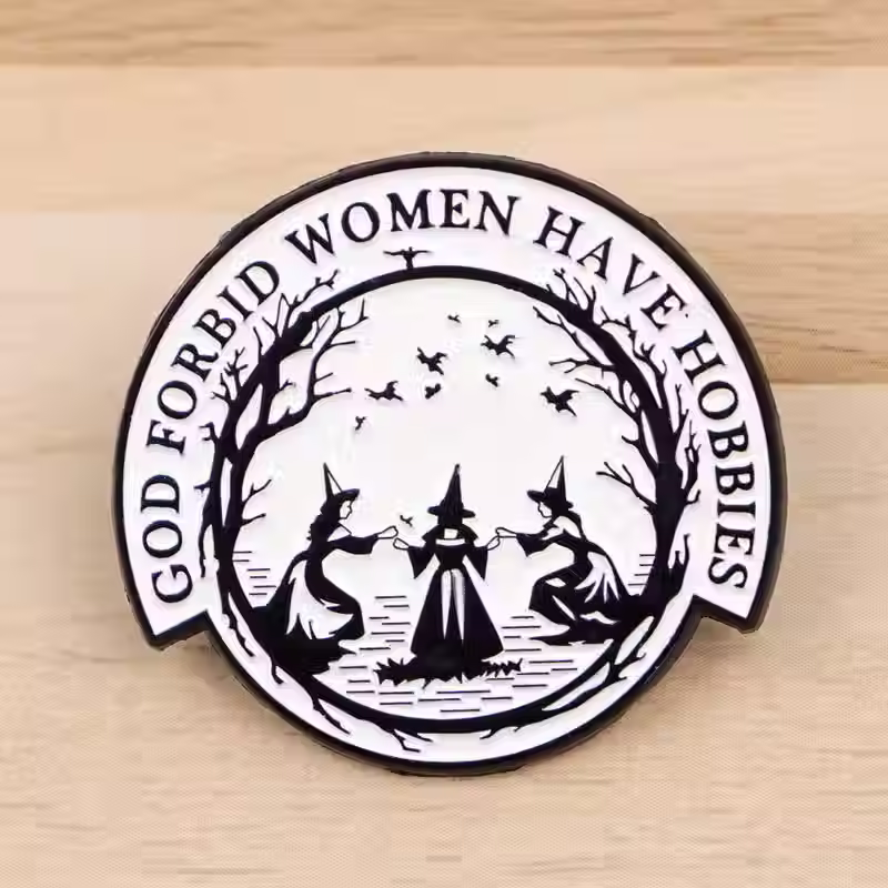 Thumbnail: Enamel pin badge saying God Forbid Women Have Hobbies