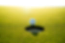 Titleist golf ball at edge of a golf hole