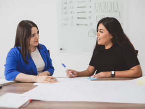 Indian women having a discussion at work.