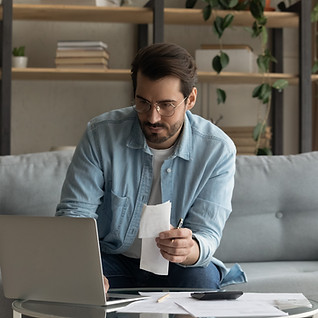 Guy withreceipt in hand with computer