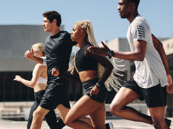 Group of male and female athletes running together