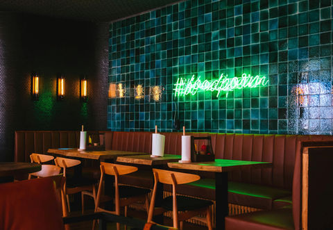 Restaurant interior with green neon #foodporn sign