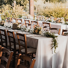 Outdoor wedding tablescape, with a white table cloth, and rustic feel