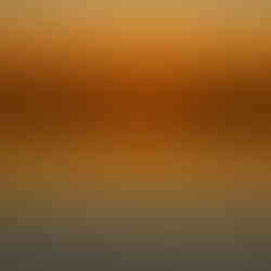 A view of the Moose River facing Moosonee at sunset, with the water gently rippled