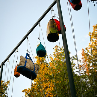 Several food bags suspended from Bear hang poles