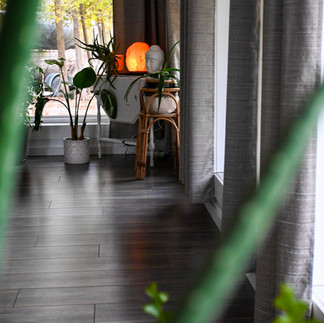 A yoga studio with plants and Buddha statues