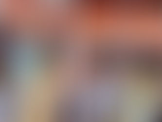 Children riding the carousel with their grandmother on the Boardwalk aboard Symphony of the Seas.