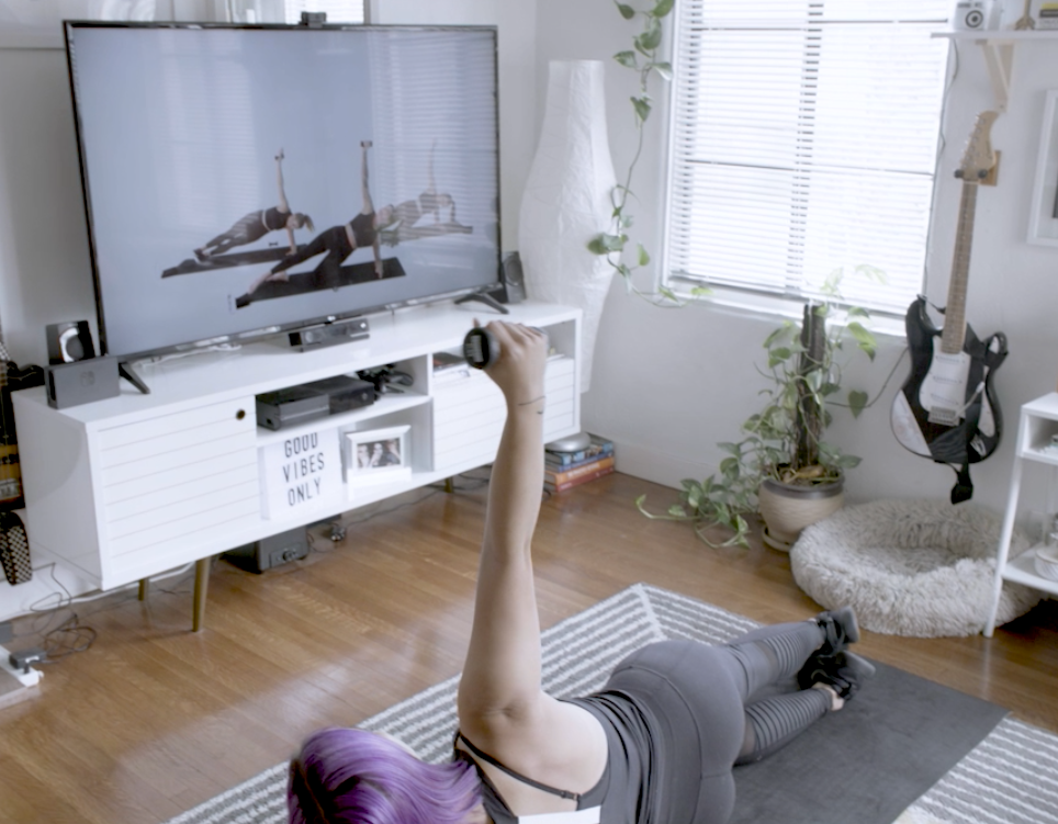 woman working out in front of TV