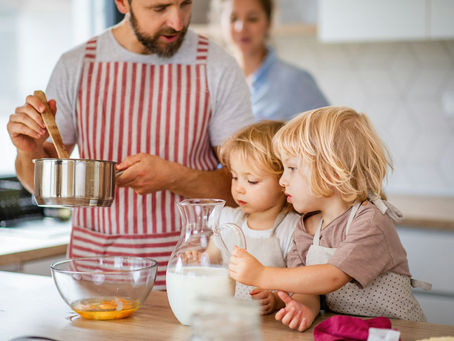 A father and two children cooking