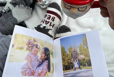 Softcover photo book by SimplePrints with images of mom holding a daughter and a dad standing behind the daughter in the park