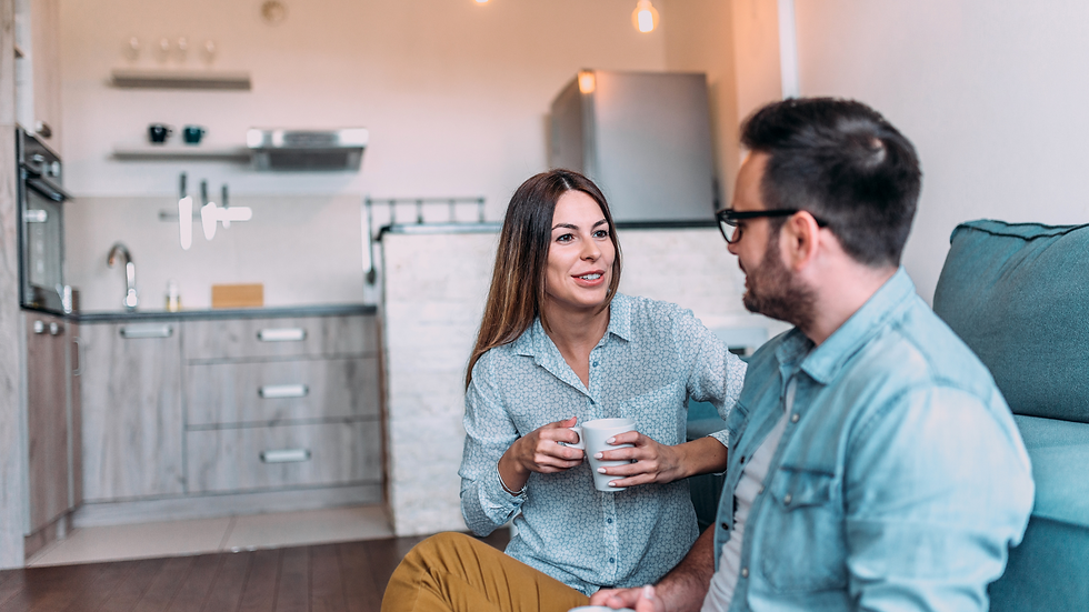 Woman and man engaged in a positive discussion while drinking coffee.