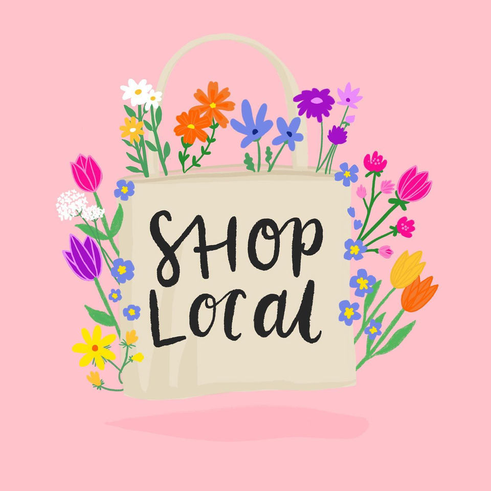 Illustrated tote bag with 'Shop Local' hand drawn across it and filled with flowers.