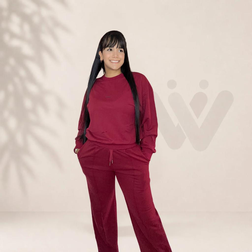 Mujer sonriente con conjunto deportivo burdeos