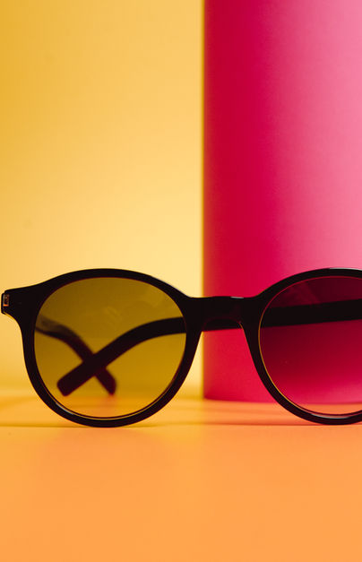 Studio product still life with sunglasses, disco ball, and glass created by 2Frames
