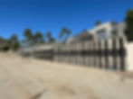 A retaining wall in California fortified with advanced carbon fiber reinforcement by the Dalinghaus team. The wall, part of a major construction project, now boasts increased strength and durability thanks to the carbon fiber applied to its surface. The Dalinghaus crew is actively working on the site, ensuring the wall's long-term stability and resilience