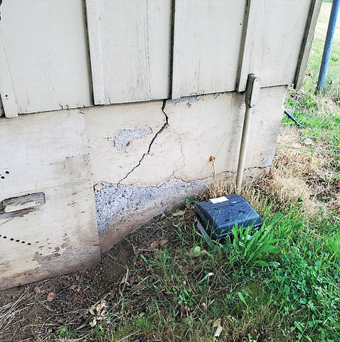 Close-up of a foundation with extensive cracking and spalling, illustrating severe concrete damage and the need for structura