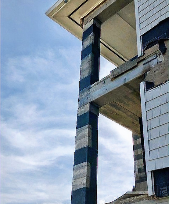 Column repaired with carbon fiber, providing reinforced support to a balcony above, ensuring enhanced strength and stability