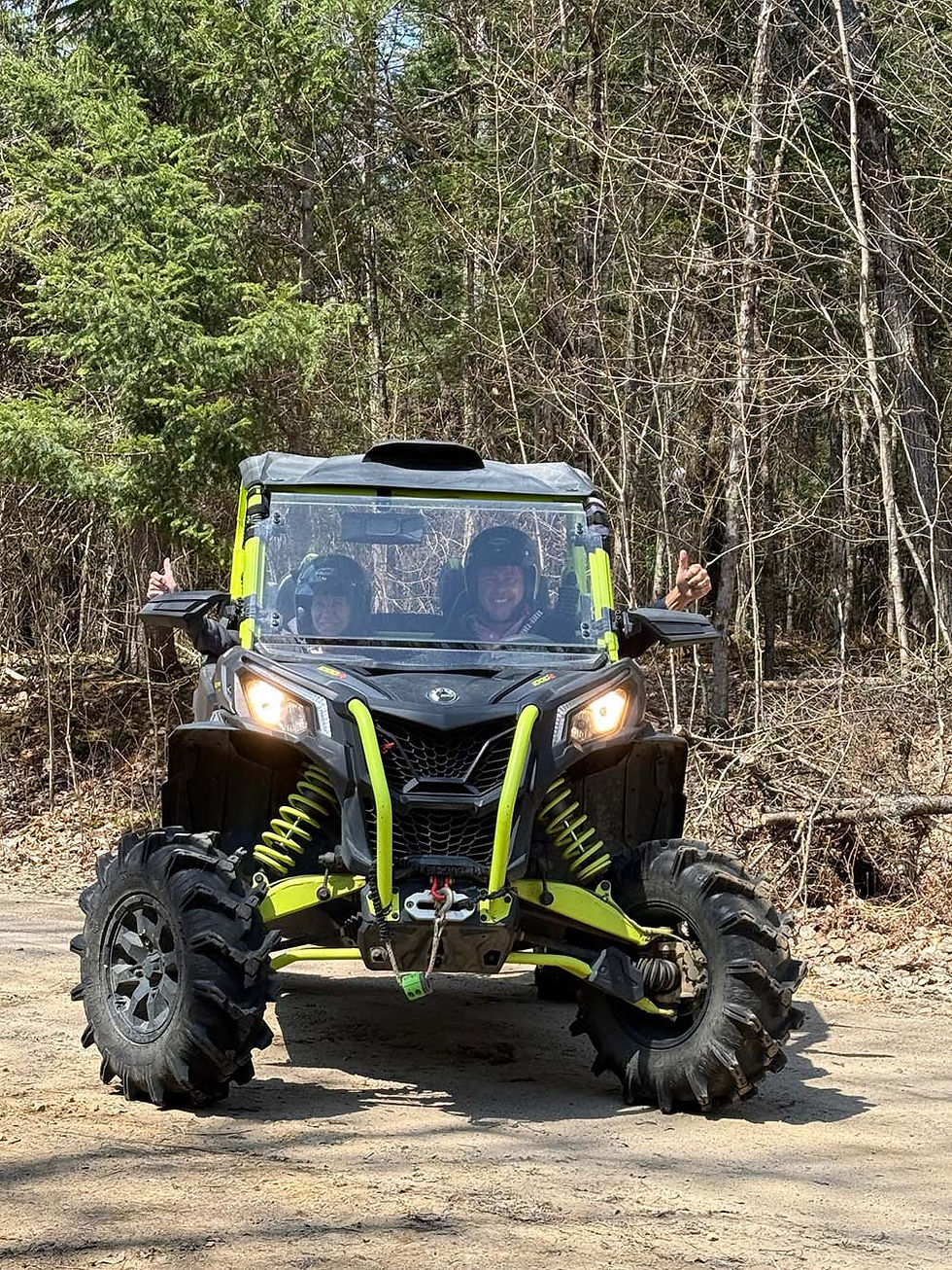 Eye-level view of an ATV crossing a forest trail in Kearney Ontario
