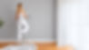 Woman painting a gray wall with paint roller in a modern apartment