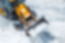 Tractor loader machine uploading dirty snow into dump truck.jpg
