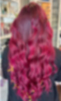 Long magenta wavy hair, back view in salon.