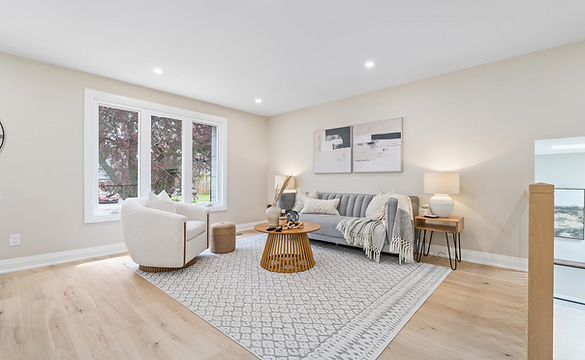 Modern living room with a soft gray sofa adorned with cushions