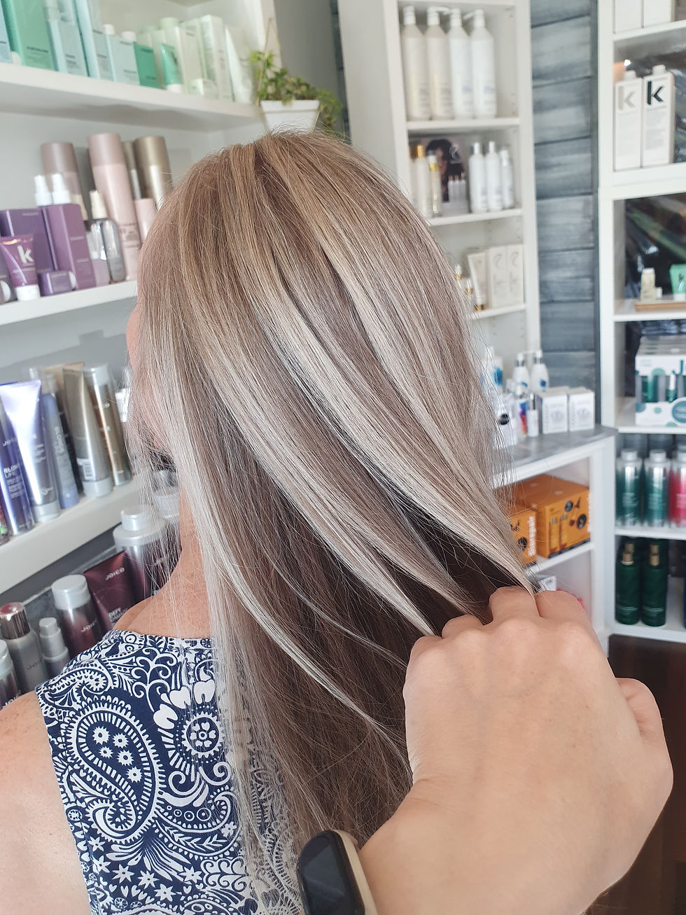 Cool blonde hair with silver lowlights in salon.