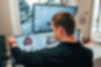 A man looking at denture structures in his computer