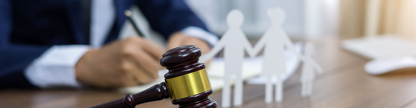 Family figure and gavel on table