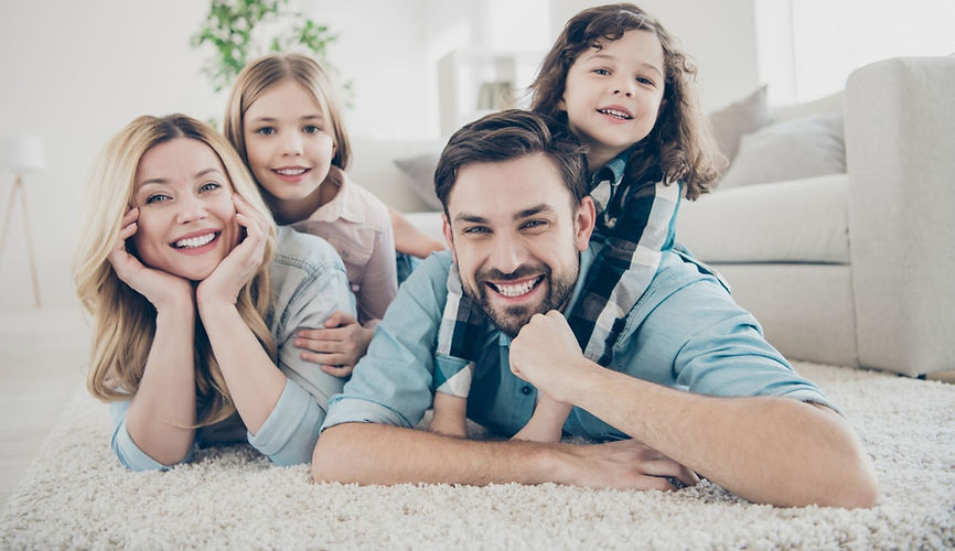 Photo of four members adopted family lying floor toothy smiling fluffy carpet cozy apartme