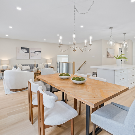 Modern open-concept dining and living room with light wood floors