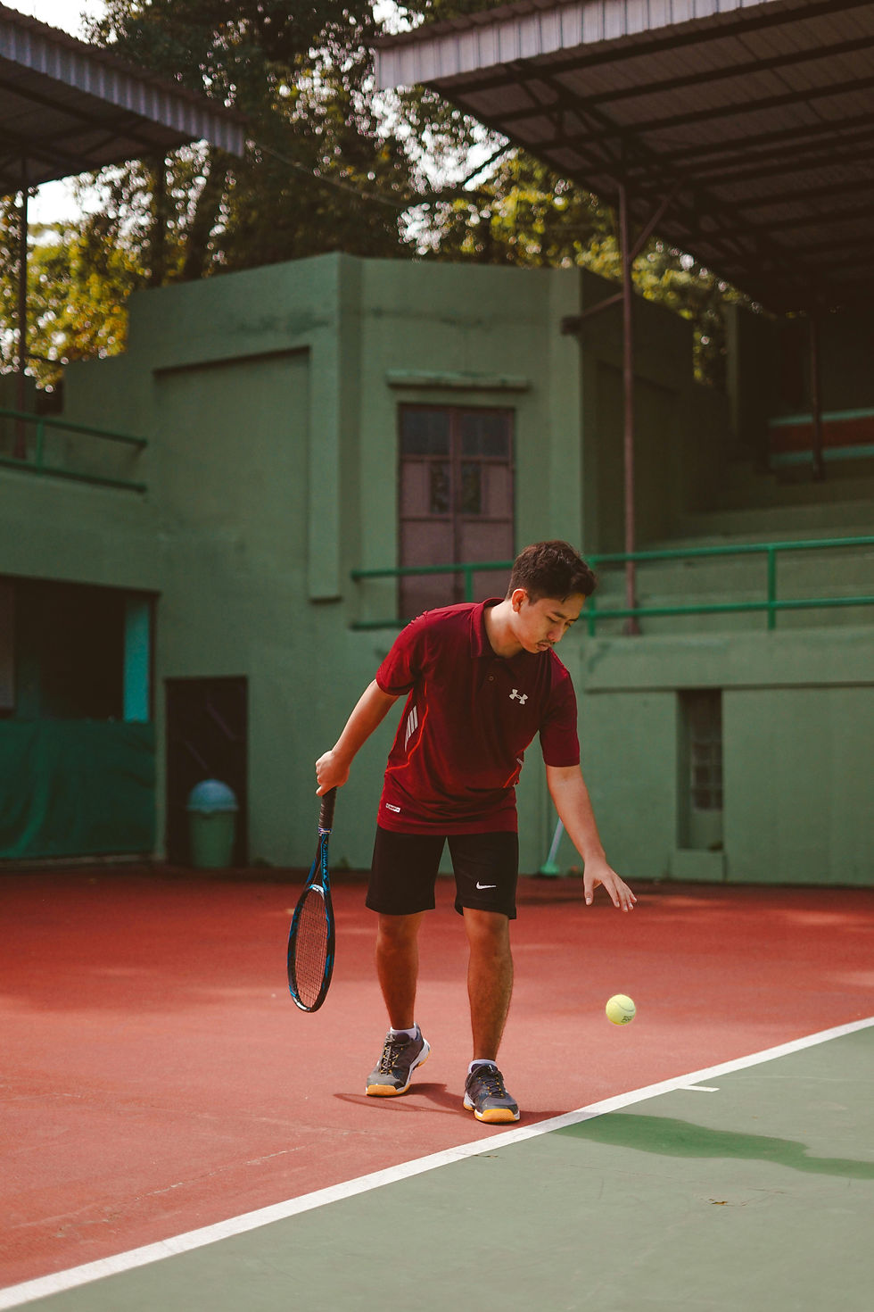 Man playing tennis on a court hitting a ball