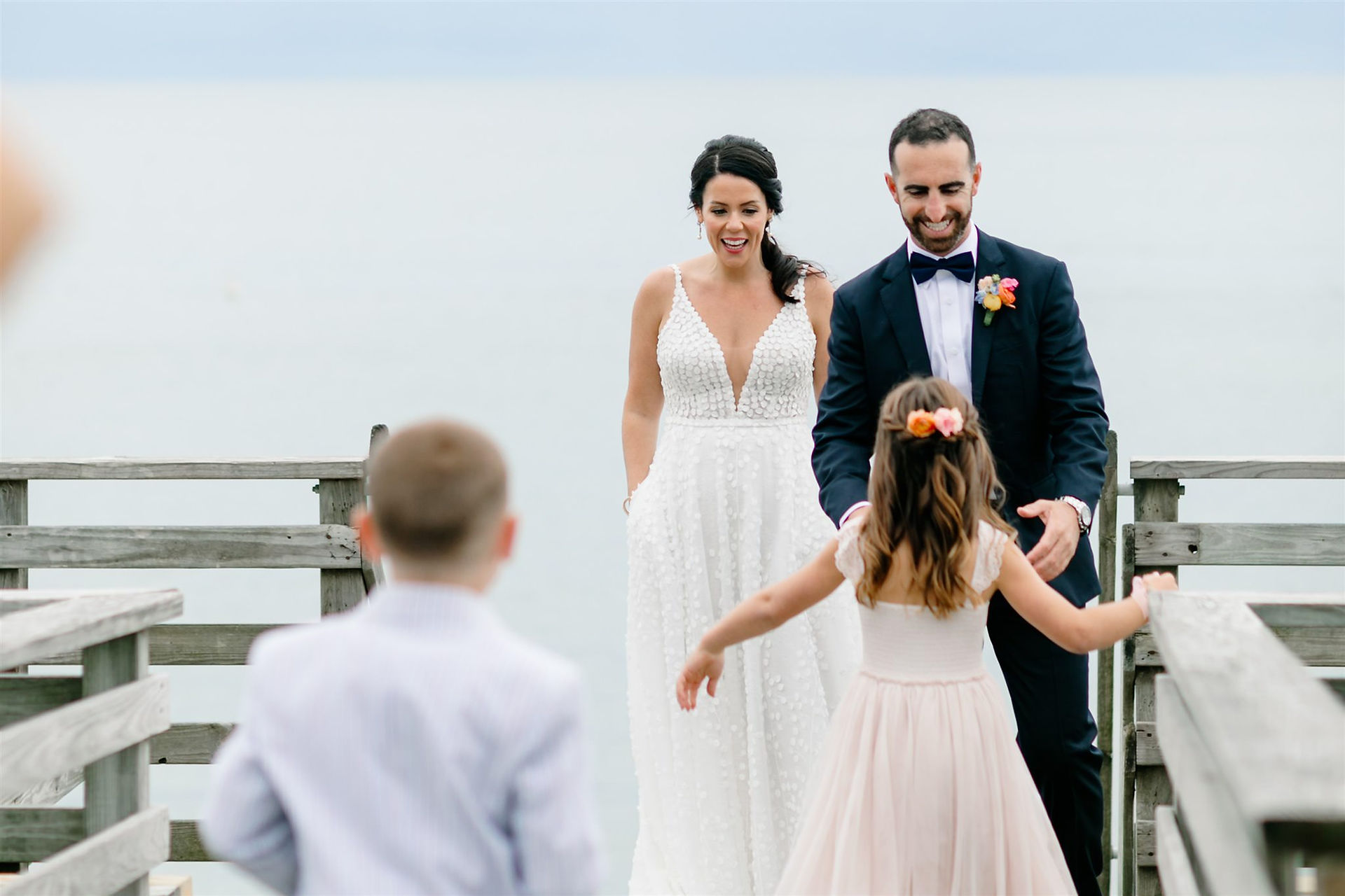 Kids running to bride and groom at Cape Cod