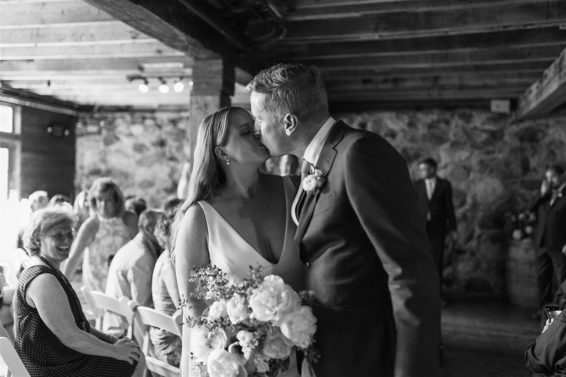 Bride and groom kissing after wedding ceremony