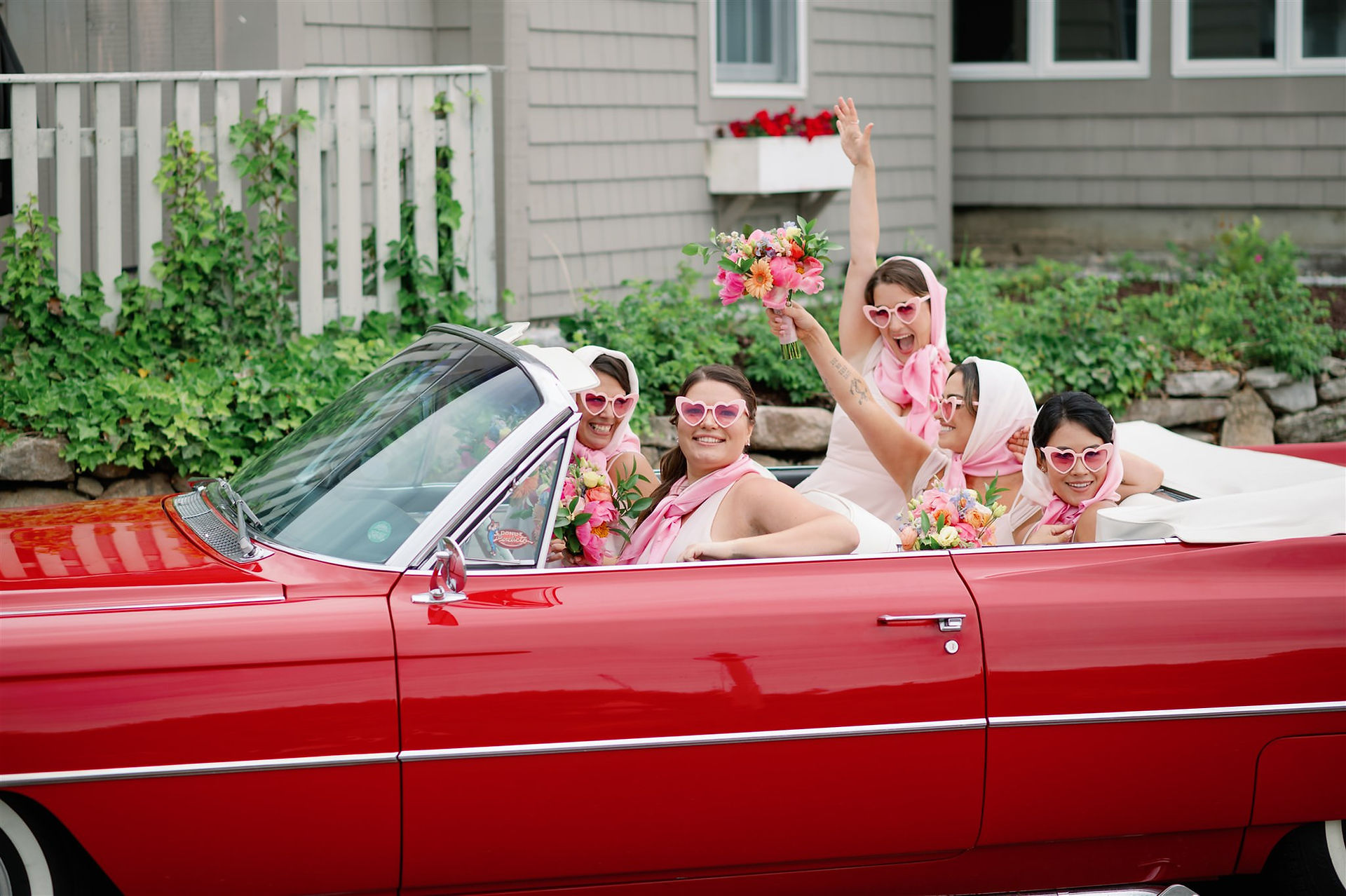 Bridesmaids in red convertible 