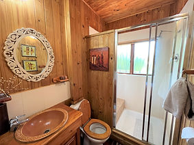 Inviting guest bathroom with a spacious mirror, stylish cabinetry, and a soothing color palette for a comfortable experience.