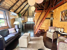 Spacious lounge and kitchen combo featuring contemporary decor, a fully equipped kitchen, and comfortable seating for relaxat